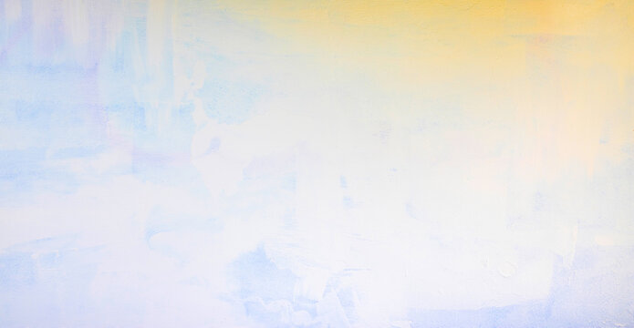 Close-up of a wall surface with a mixture of yellow and pale azure paint texture background.
