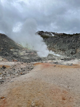 Volcanic Steam Rising from Geothermal Terrain Under Cloudy Sky