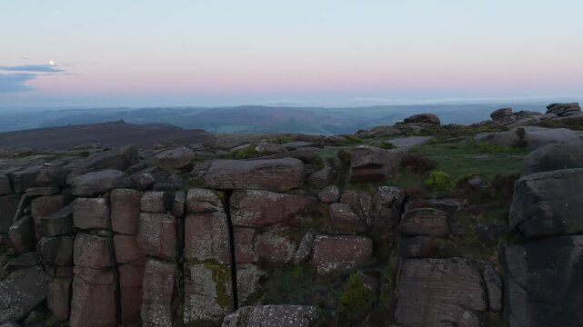 Drone flight over Higger Tor towards the Burbage Valley at sunrise