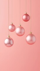 Fototapeta premium Elegant pink Christmas baubles hanging against a soft pastel background with a festive minimalist holiday design.
