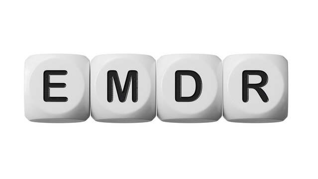The text EMDR word Eye Movement Desensitization is written on notepad . Medical concept.close up of wooden dice,Business Concept.Supports PNG files with transparent backgrounds.