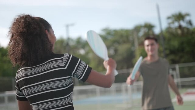 Pickleball athletes male and female walking to the net and tag their paddles above the net serves as a greeting before a pickleball match or outdoor training and exciting games together. Healthy,
