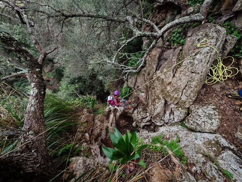 Descending the Son Gallard Ravine (Torrent de Son Gallard ) with a rope, on the coast between Valldemossa and Dei&agrave;, Natural area of the Serra de Tramuntana., Majorca, Balearic Islands, Spain