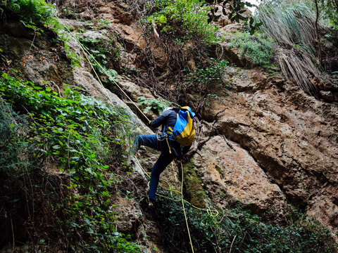 Descending the Son Gallard Ravine (Torrent de Son Gallard ) with a rope, on the coast between Valldemossa and Dei&agrave;, Natural area of the Serra de Tramuntana., Majorca, Balearic Islands, Spain