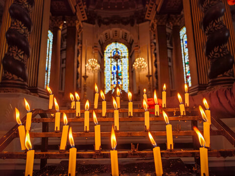 votive candles in front of a window with a cross, Saint Paul's Cathedral, London, England, Great Britain, Europe