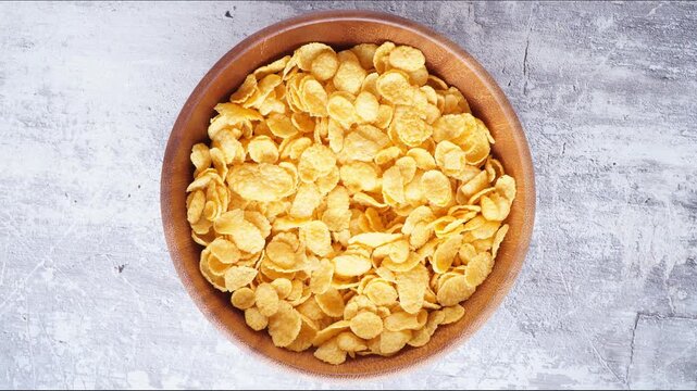 Stopmotion: eating cornflakes from a wooden bowl
