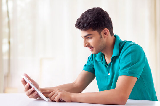 Student using Mobile Phones at the desk
