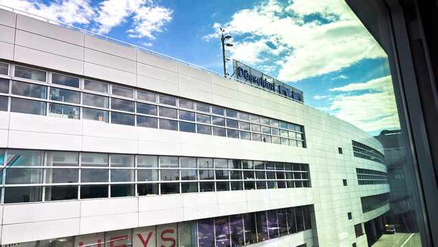 Dusseldorf Airport terminal building. The "Dusseldorf DUS" logo is visible on the top of the building.