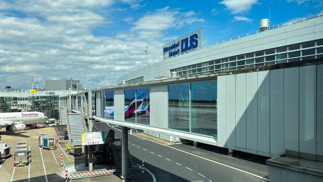 Dusseldorf Airport terminal building. The "Dusseldorf DUS" logo is visible on the top of the building.
