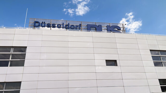 Dusseldorf Airport terminal building. The "Dusseldorf DUS" logo is visible on the top of the building.