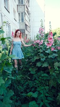 Beautiful girl, young woman is smoking IQOS by Philip Morris, modern hybrid electronic cigarette device, technology, heating new tobacco system, puff. Healthy safety alternative to smoking. Healthcare
