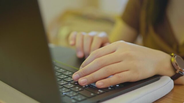 Close-up of hands typing on a laptop keyboard, representing remote work, online business, productivity, digital workflow and modern office technology