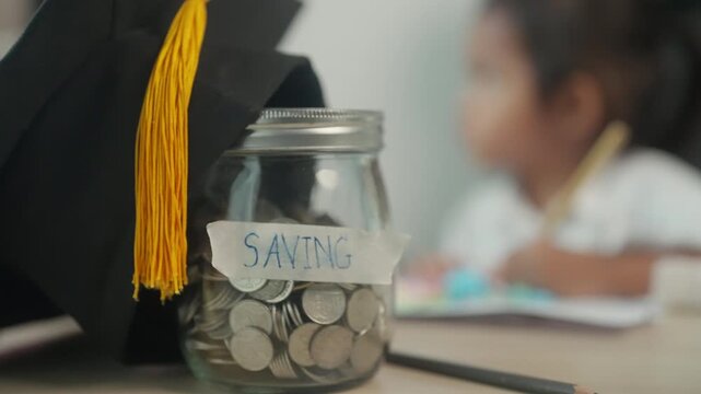Graduation Cap and Savings Jar Symbolizing Education Investment and Child's Future