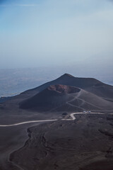 Mount Etna. Volcanic landscape with winding road and mediterranean sea, Sicily, Italy © Joneaz