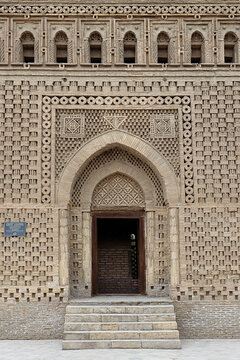 Ismail Samani Mausoleum entrance facade in Bukhara showing intricate geometric brickwork patterns. Historic Samanid dynasty tomb ideal for travel guides, architecture publications.