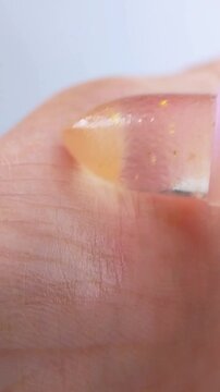 Close up view of shining or glossing palm using lip balm cosmetic product. Suitable for beauty product theme background, glossy texture concept.