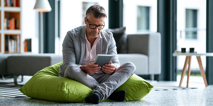 Man using tablet in modern living room