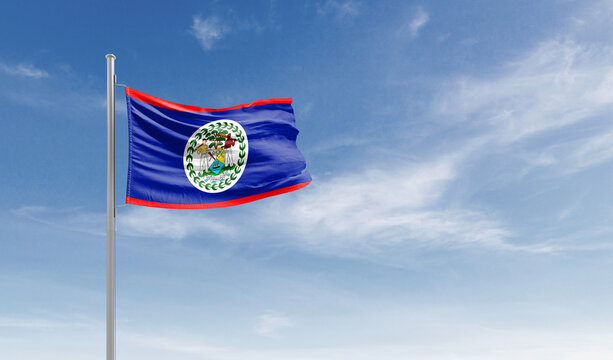 Belize national flag waving in the sky.
