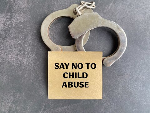 Say No to Child Abuse message with handcuffs representing child protection, violence prevention, justice and public awareness campaign.