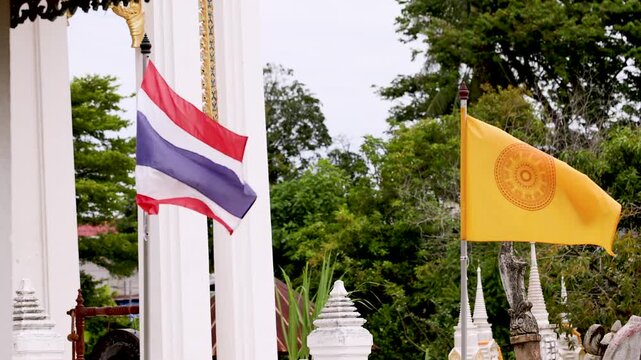 Thai and Buddhist Flags Waving at Temple Entrance in Koh Kret