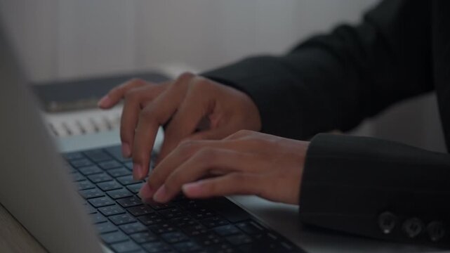 Business Professional Typing on Laptop Computer During Office Work