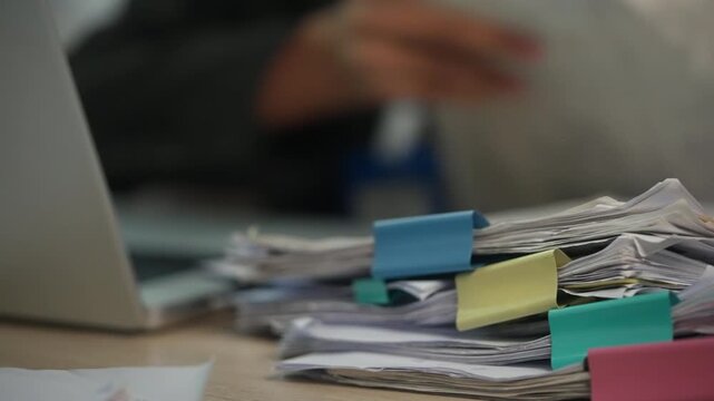 Stack of Business Documents with Color Tabs for Office Filing and Administrative Workflow