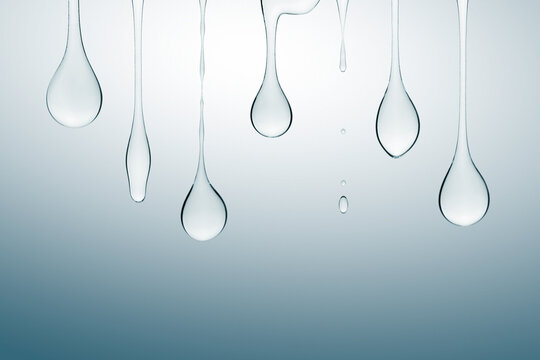 Transparent cosmetic gel dripping down on blue background.