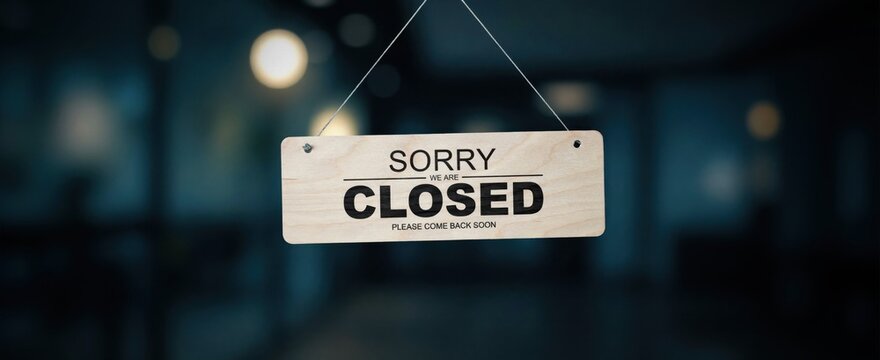 Sorry we are closed wooden sign hanging on glass door, business or shop temporarily shut down.