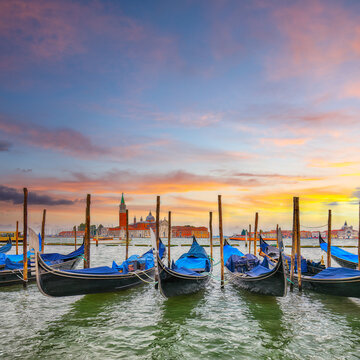 Amazing  landscape with Church of San Giorgio Maggiore  and gondolas parked beside the Riva degli Schiavoni in Venice