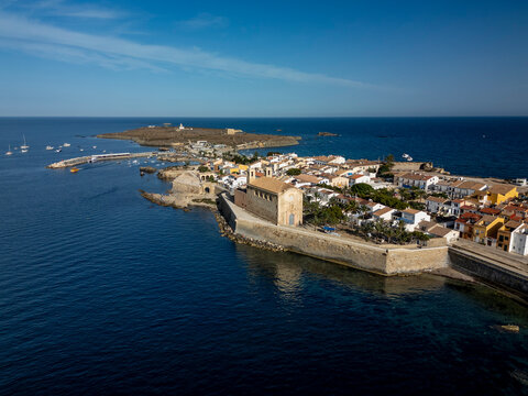 Tabarca island coastal town on mediterranean sea with historic architecture, harbor, and boats under clear blue sky, a popular travel destination in Alicante, Spain - stock photo