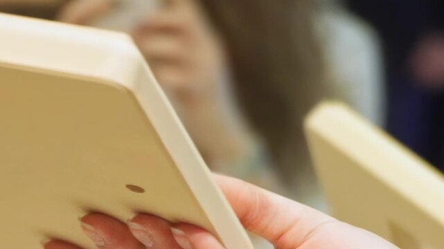 See skilled hands meticulously turning and fitting a smooth, light wooden block. This intimate perspective showcases focused concentration on a hands-on crafting project.