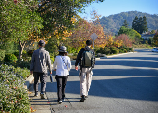 People walking at the corner of a street. Walkable city in autumn colour. California.