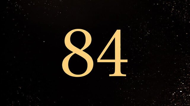 Gold Glitter Blow‑Away Reveal of Number 84 on Solid Background