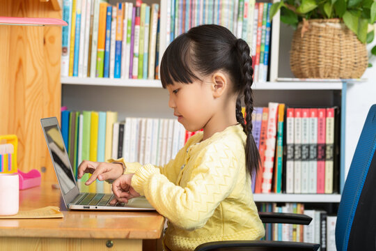 cheerful Asian girl using laptop for online class at home, distance learning and e-education concept.