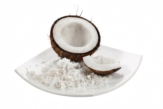 Fresh Halved Coconut and Grated Flakes on White Plate