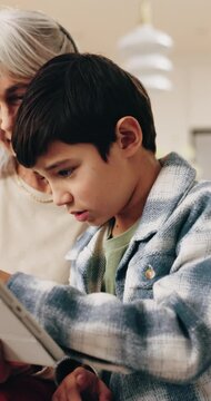 Smile, grandma and child at house with tablet, browsing and download ebook for education. Happy, senior woman and kid in lounge with digital, watching video and educational games for online learning