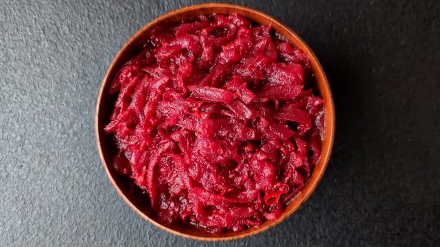 Grated beetroot with salt and spices as an ingredient for borscht or a vegan salad. Grated beetroot as a food background for your design