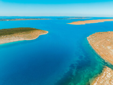 Vrsi near Zadar archipelago cove beach in stone desert scenery near Zecevo island, Dalmatia in Croatia and Pag Island in background.