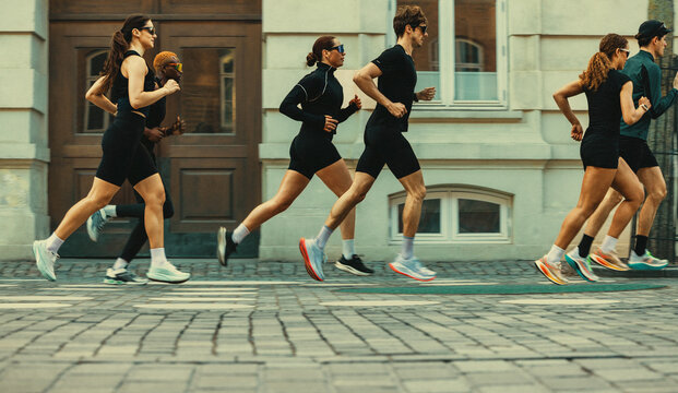 Group running through the city during a run club workout