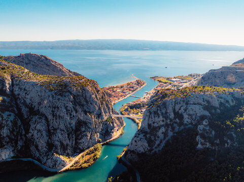 Aerial view of Omis city and the Cetina river canyon meeting the Adriatic sea, featuring historic Mirabella fortress and mountains, Dalmatia, Croatia