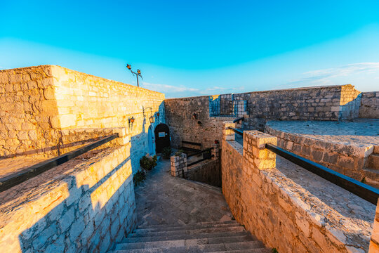 Stunning sunset over Hvar town and Pakleni Islands viewed from the medieval Spanish Fortress, golden hour over the Adriatic sea, Croatia.