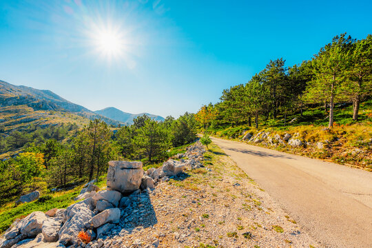 Rugged karst landscape of Biokovo Nature Park with white limestone rocks and sparse mediterranean vegetation, Dalmatia, Croatia.