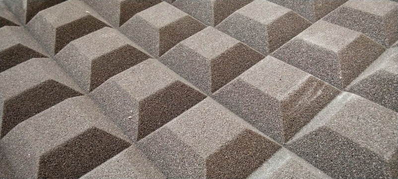 Grey pyramid-shaped acoustic foam panels for sound dampening and studio acoustic treatment.
