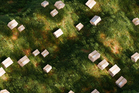 3D scattered parcel landscape showing boxes across green grass