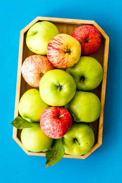 Healthy diet concept. Fresh apples in tray on blue background top view