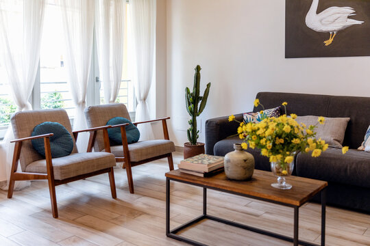 Sofa and chairs arranged in living room at home