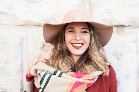 Portrait of a smiling stylish woman wearing a floppy hat