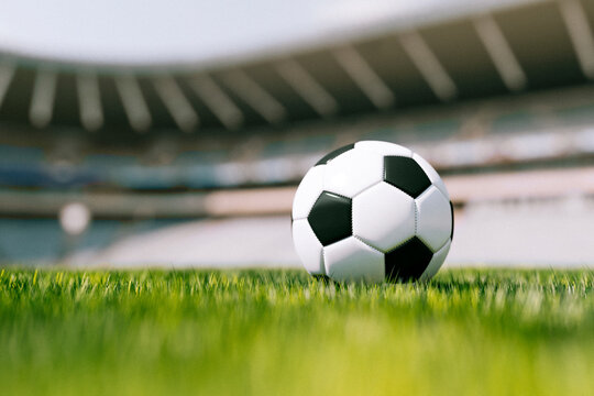 3D render of a soccer ball on green grass in an empty stadium
