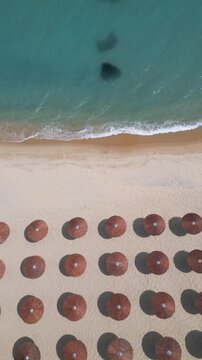 Top Down Aerial View of Beach Umbrellas on Sandy Coast and Sea