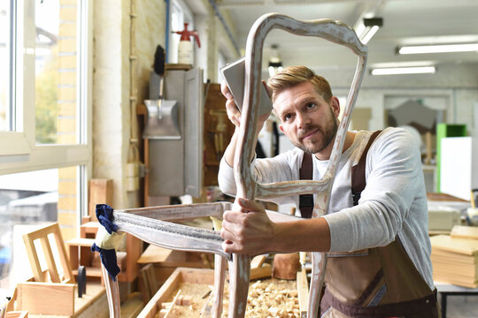 Carpenter restoring a wooden chair